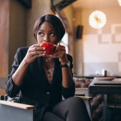 african-black-business-woman-drinking-coffee-bar